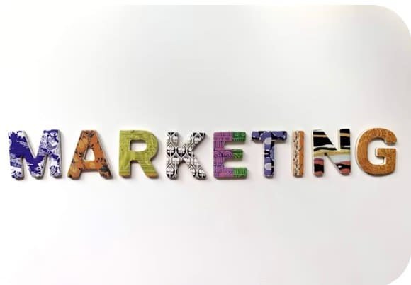The word MARKETING spelled in patterned cut-out letters